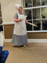 President completing a cookery quiz set by the club Image