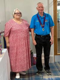 Di handing over the DG Gong to Tim Image